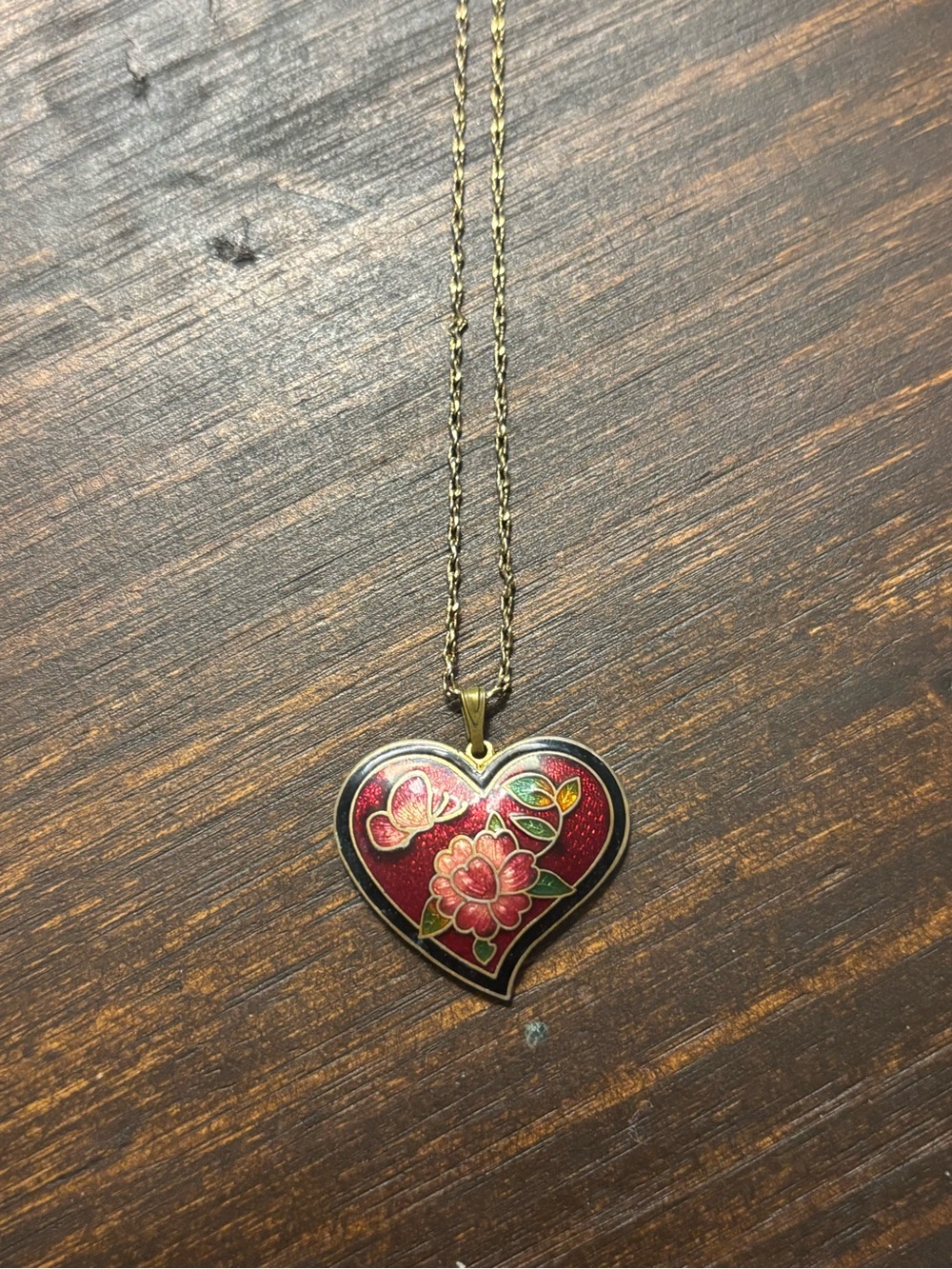 butterfly floral heart pendant on a gold toned chain